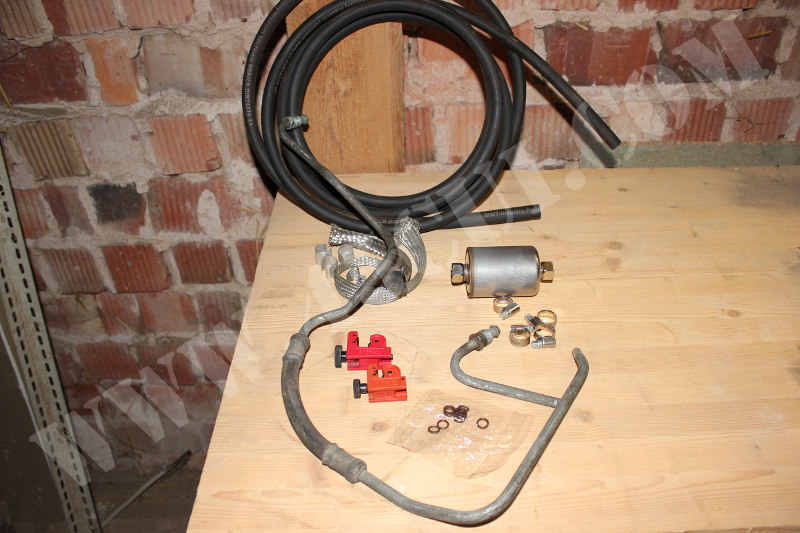  Rubber fuel line, steel-flex cover, fuel filter, tiny pipe cutter, hose clamps, fuel line o-rings and an old fuel line